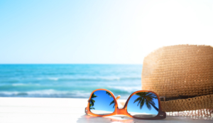 sunglasses and hat on a beach
