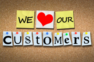 we love our customers on corkboard
